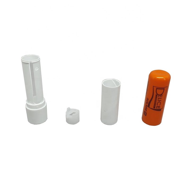 Molded cosmetic tube components: white lip balm tube parts and an orange lipstick cap