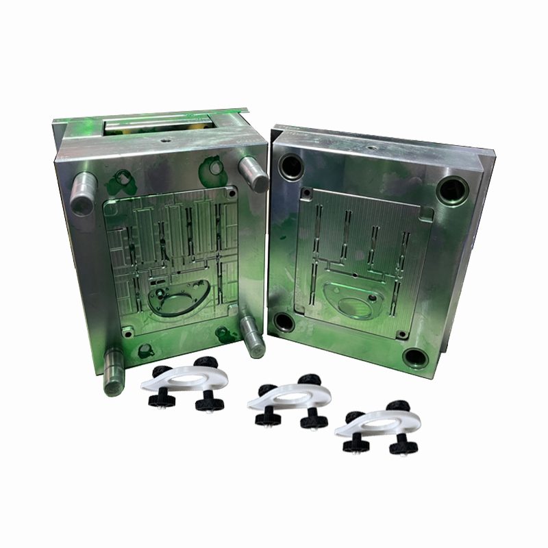 Family injection mold in a green painted mold base with small molded plastic clips in front
