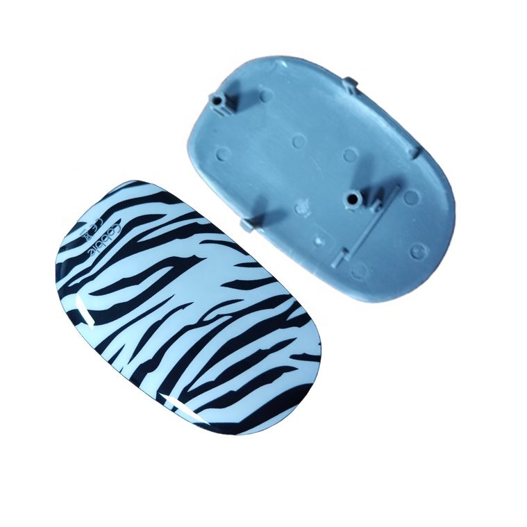 Small injection molded shells with printed in-mold patterns, including an animal print design