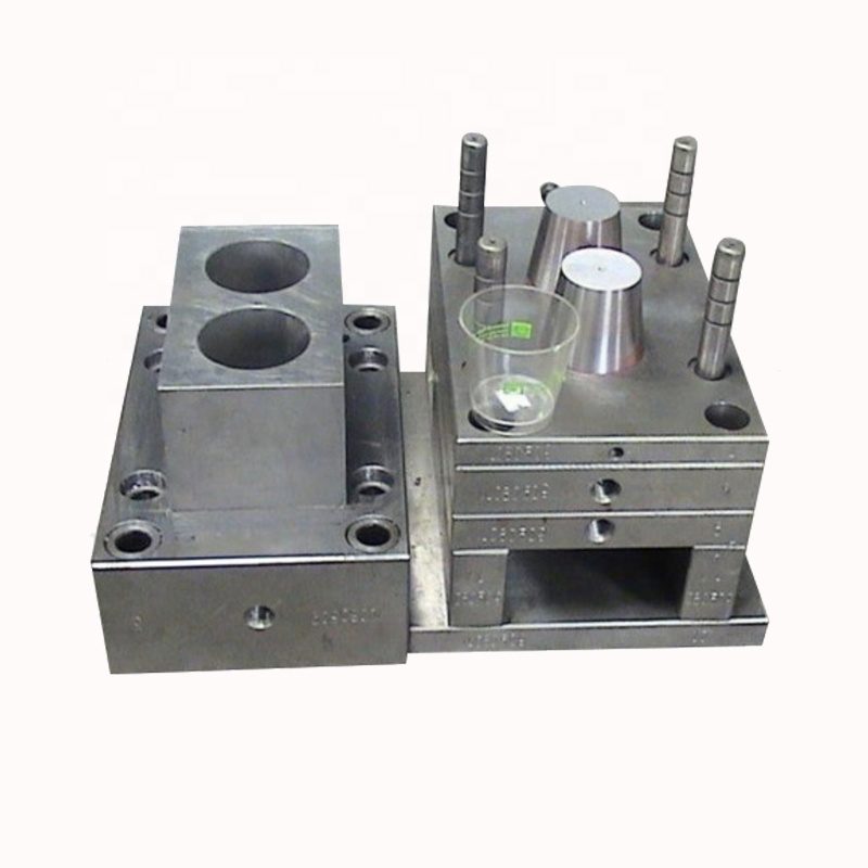 Two-cavity injection mold with a bright machined cavity block and two round cavity pockets