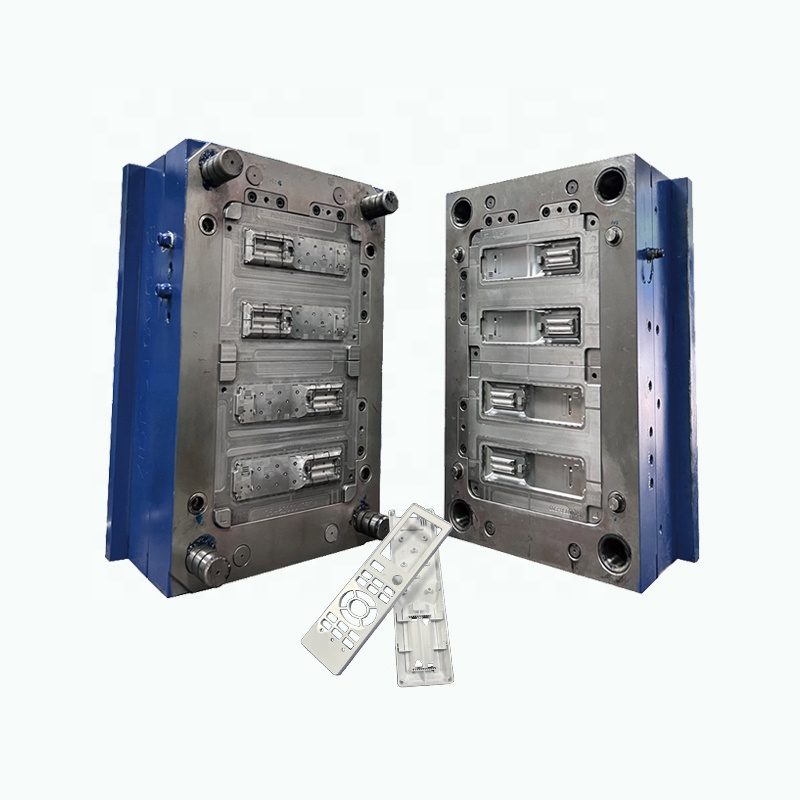 Segmented insert injection mold in a blue mold base with two flat molded parts in front